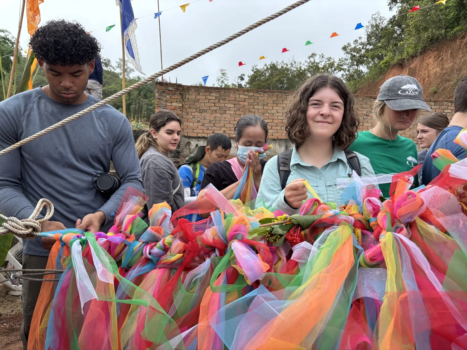 Participants and community members gathering around colourful decorations