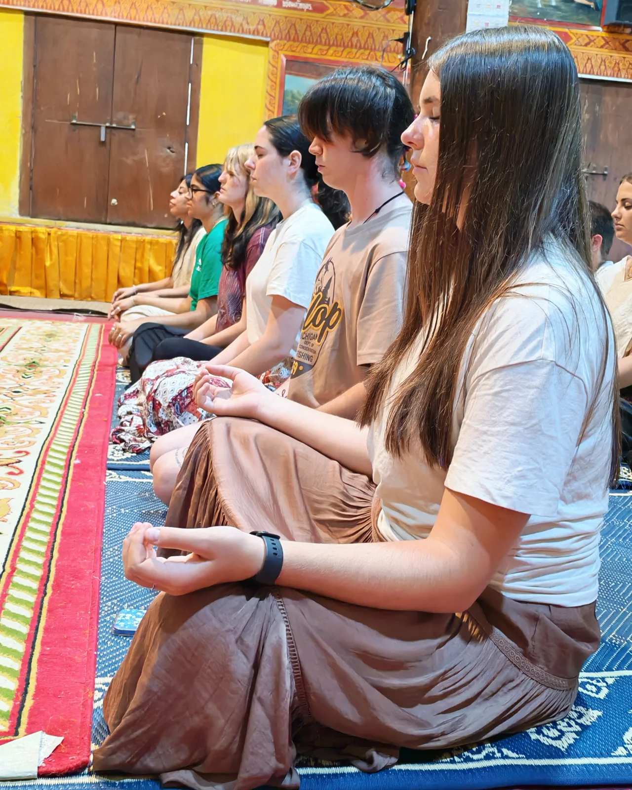 Participants seated inside a temple