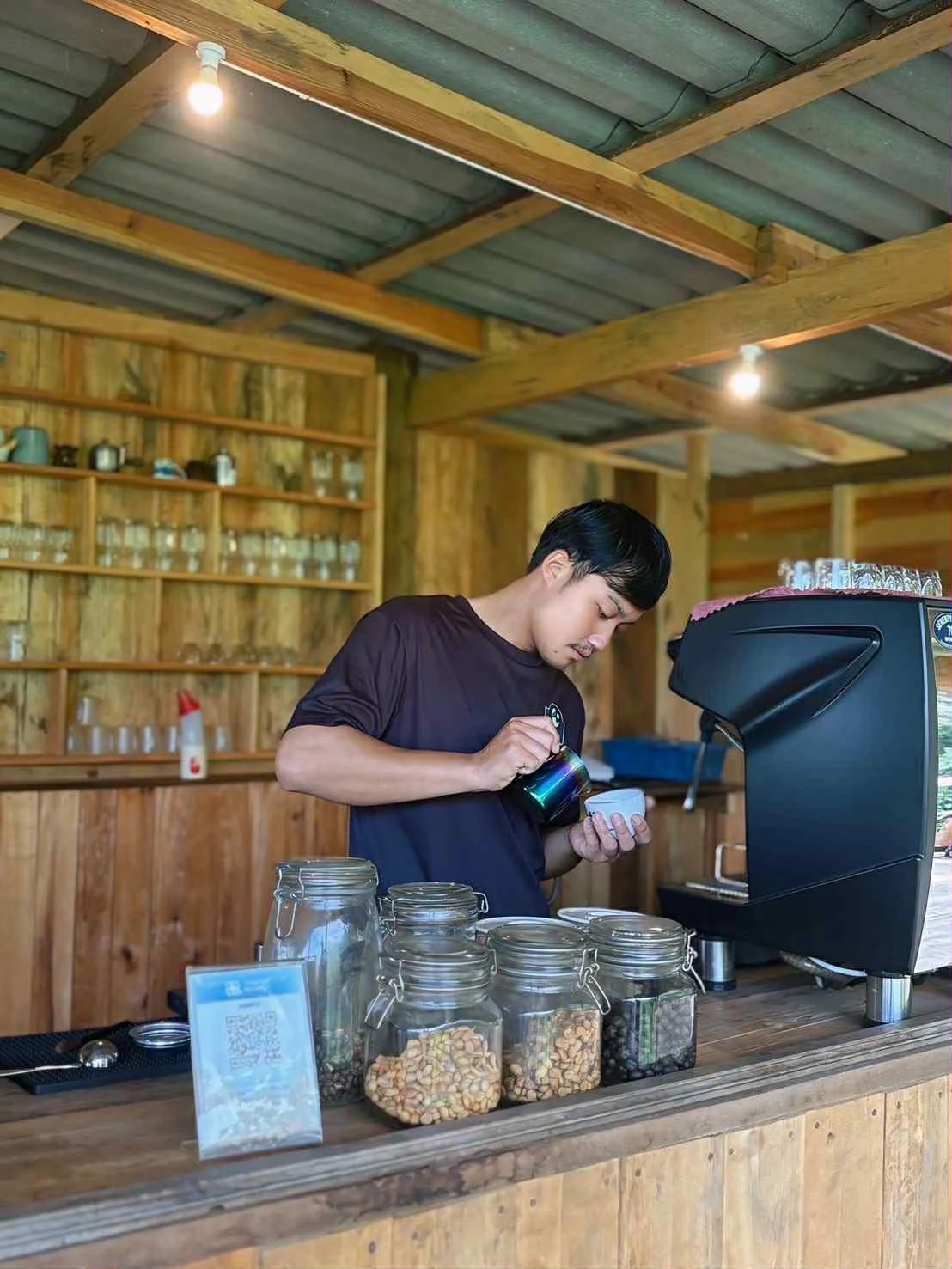 Wyn making coffee behind the counter