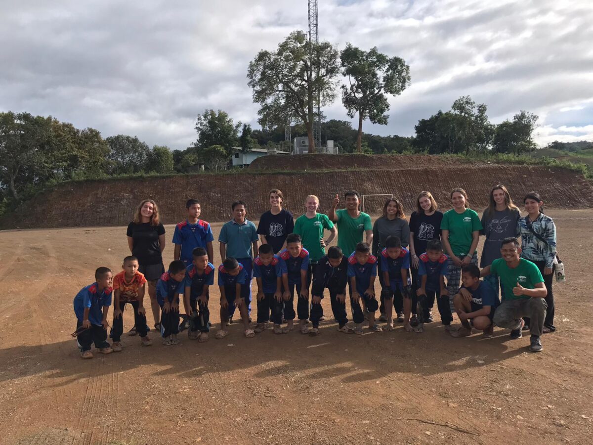 Home Visiting participants and local children together on a school playing field